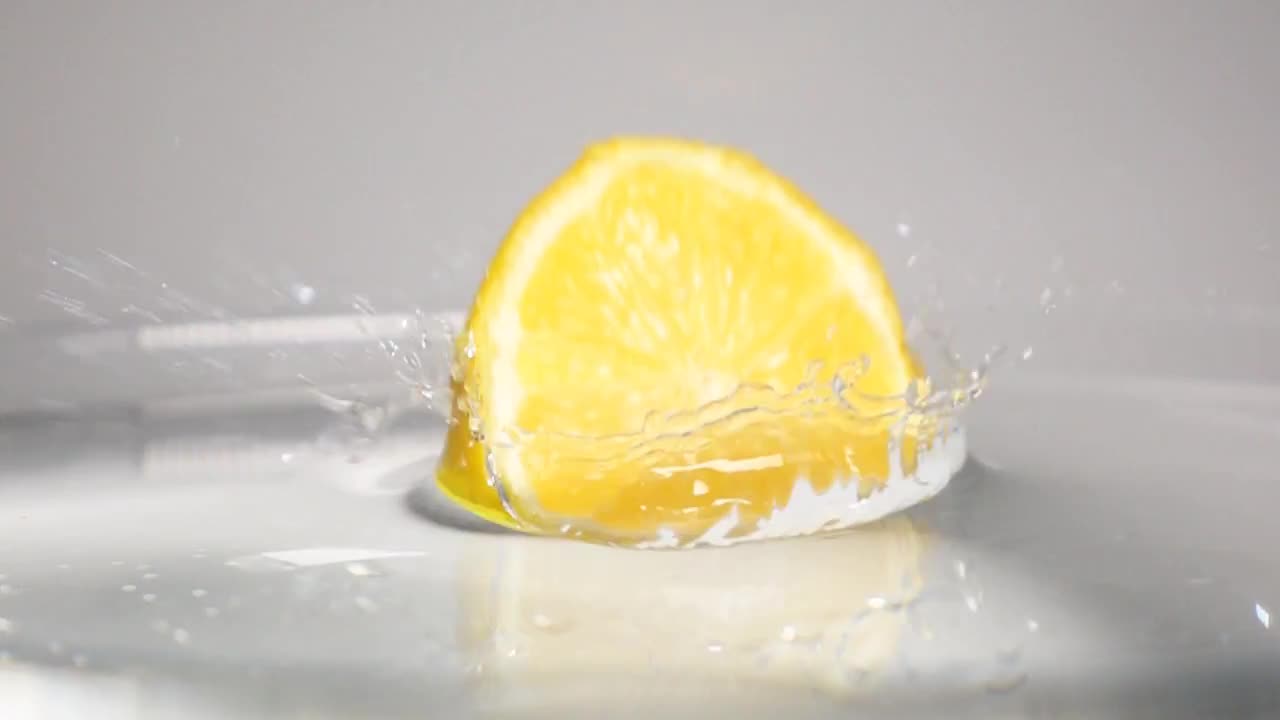 Half Lemon Dropped Into Water Stock Video Motion Array