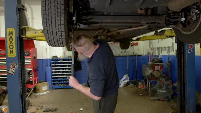 Auto Mechanic Moving Wheels Vehicle Repair Service Shop Man