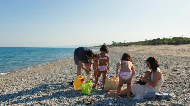 Dad Undressing His Children Before The Sea Bath - Stock ...