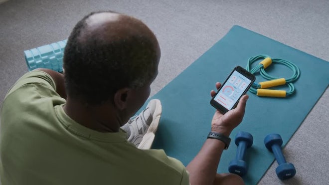 https://motionarray.imgix.net/elderly-black-man-checking-fitness-app-on-smartphone-while-exercising-at-home-3811682-high_0001.jpg?auto=format&fit=max&q=60&w=660