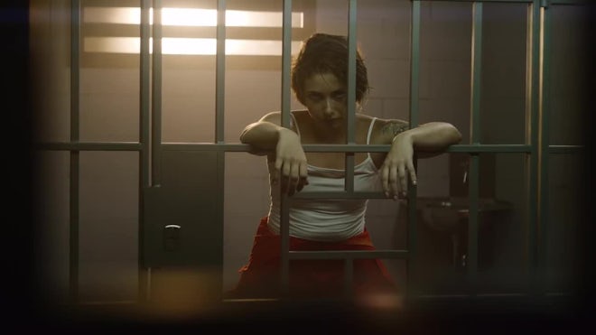 Female Criminal Stands In Prison Cell, Looks At Camera - Stock Video | Motion Array