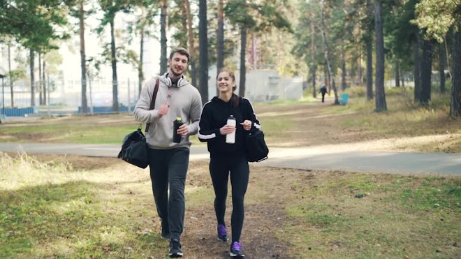 Couple Walk In Park In Sportswear - Stock Video