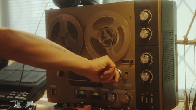 Hand Of Man Turning On Vintage Reel-to-Reel Audio Tape Recorder