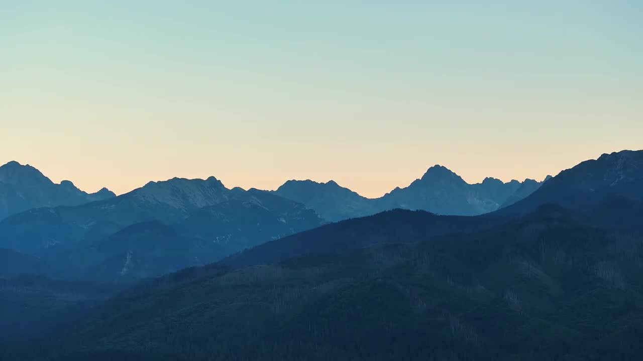 Majestic Mountain Silhouettes Captured At Dawn In Serene Landscape