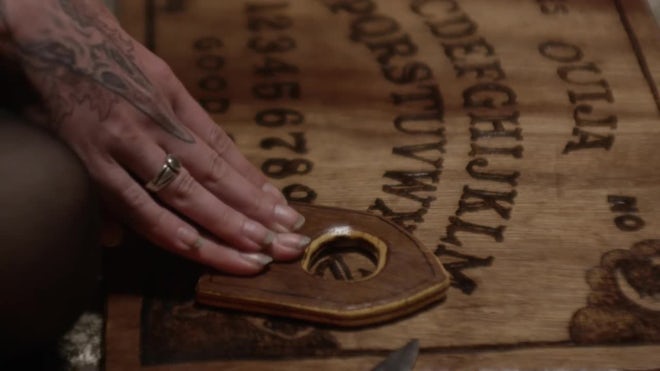 Hands Moving Planchette Over Ouija Board - Stock Video | Motion Array