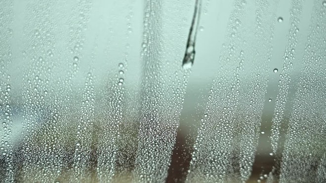 Water Drops on the Windshield in a Car Washer Blowing Stock