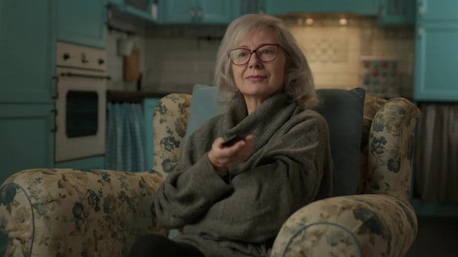 Mature Woman Watching TV - Stock Video | Motion Array