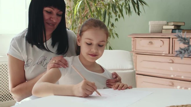 Mom And Daughter Drawing With A Pencil - Stock Video