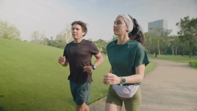 Young Couple Running In A Park - Stock Video