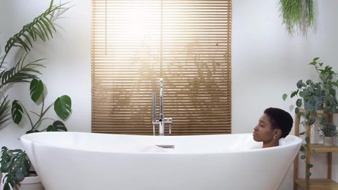 Woman taking bath in bathtub at bathroom, Stock Video