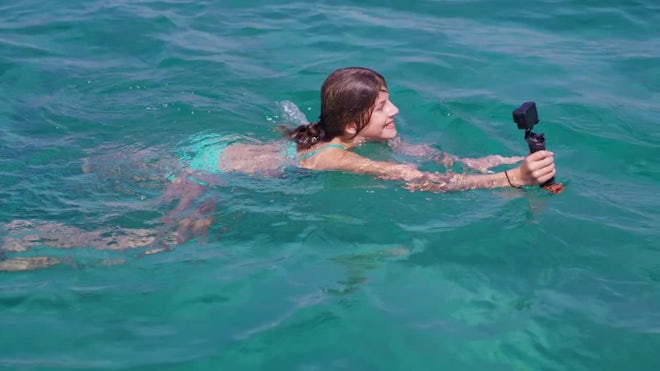 Teen Swimming While Taking A Selfie - Stock Video | Motion Array