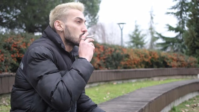 Man Smoking Cigarette In A Park - Stock Video