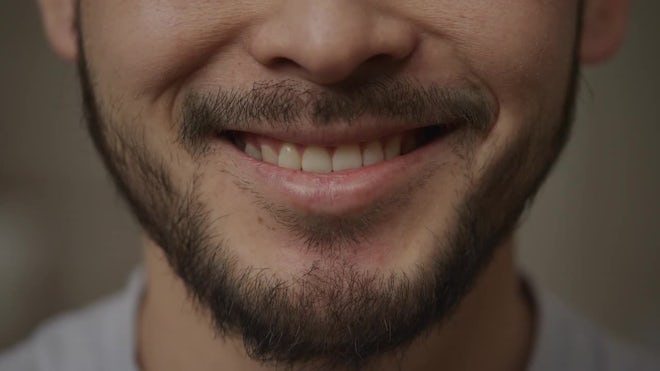 A CLOSE UP of a man smiling menacingly, , Stock Video