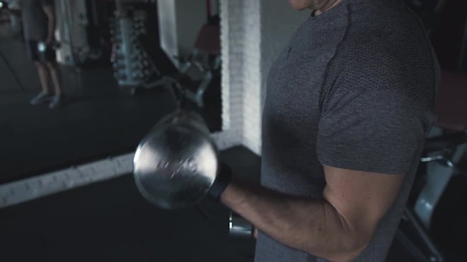 People In The Gym Lifting Dumbbells - Stock Video