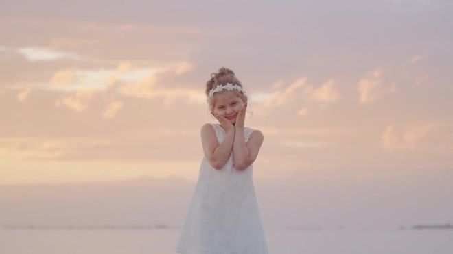 Little girl wearing a dress playing in a, Stock Video