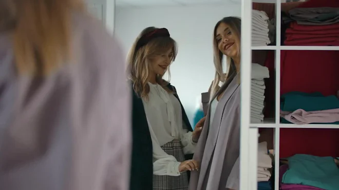 ladies dressing room videos Woman with long hair looking through her dress on bed in room happy to get out after quarantine