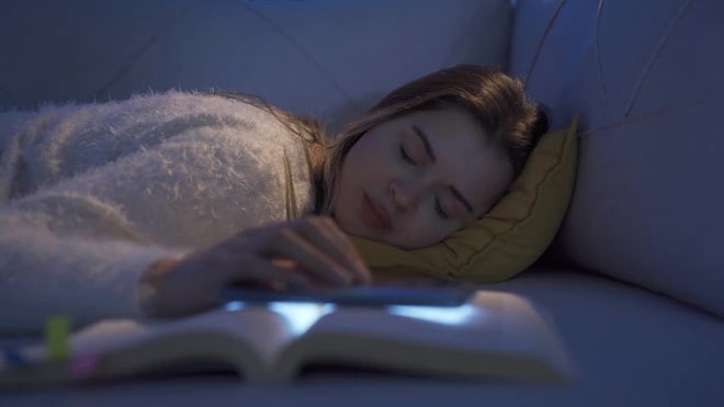 Girl Falling Asleep On Sofa At Night - Stock Video
