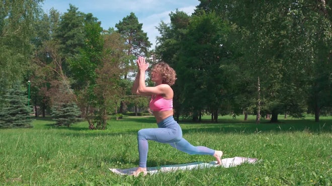 Flexibility exercises. Athletic young woman doing yoga on mat, stretching  her legs during home Stock Photo by Prostock-studio