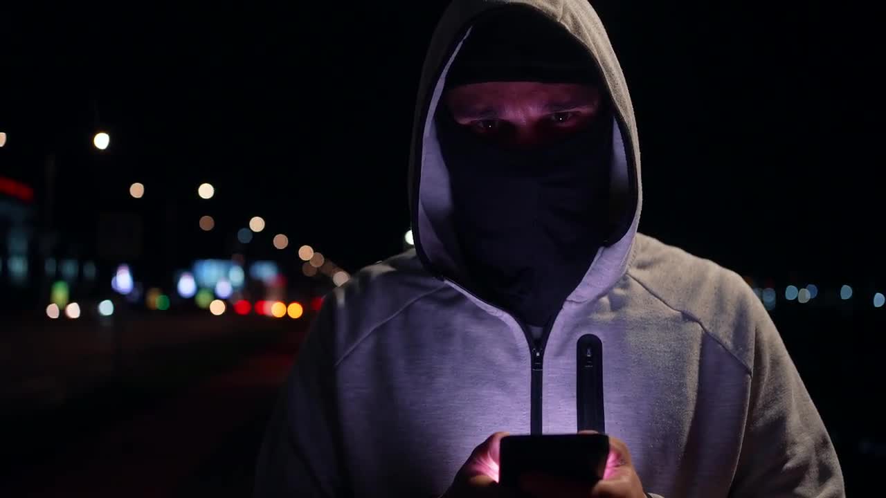 Hacker In A Balaclava At Night - Stock Video | Motion Array