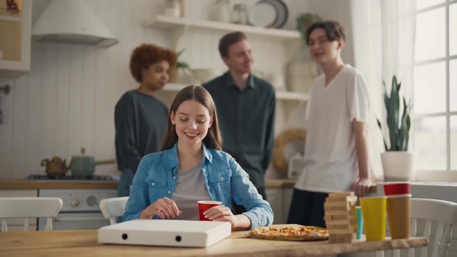 Happy african american friends eating pizza at home Stock Photo by  Prostock-studio