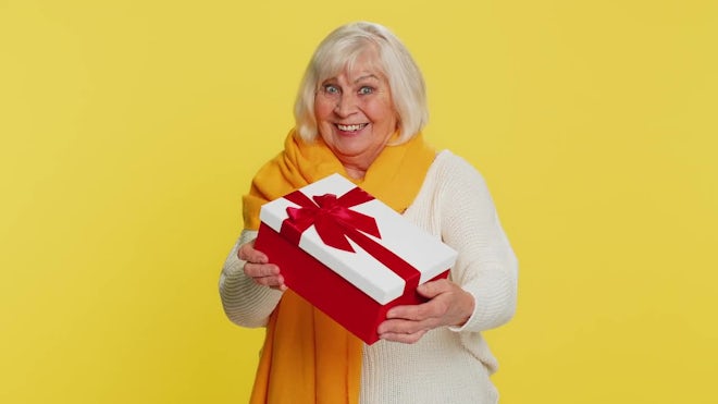 Elderly woman with gifts, Stock image