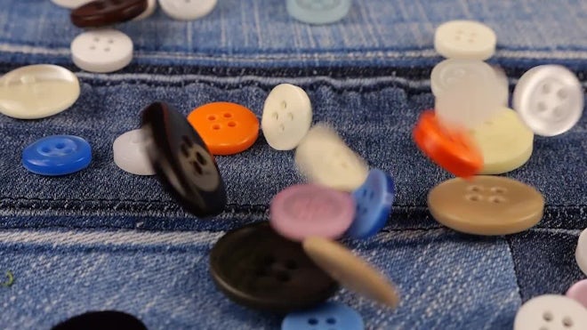 Multi-colored Buttons Fall On Denim - Stock Video