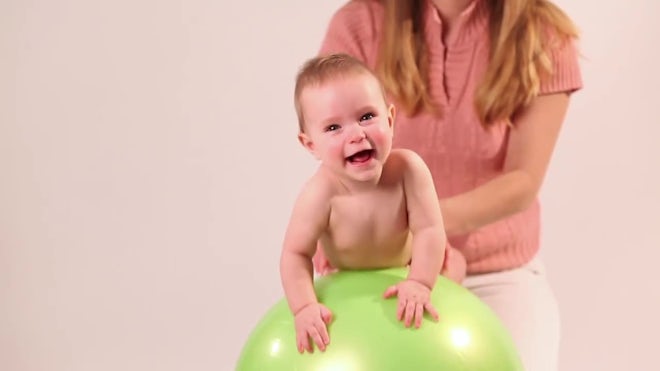 naked mom and child Mom Swings Her Naked Baby On An Exercise Ball - Stock Video | Motion Array