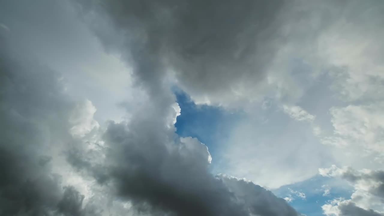 Dark Storm Clouds Moving And The Hole With A Piece Of Blue Sky