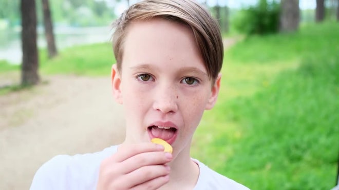 Young Teen With Snack - Stock Video | Motion Array