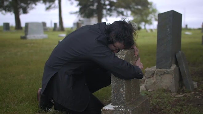 Sad Young Man Crying At Grave Tombstone In Cemetery - Stock Video | Motion  Array
