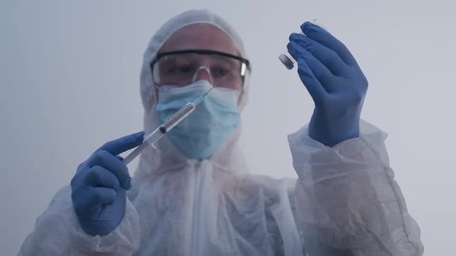 Woman Removing Full Syringe From Bottle - Stock Video | Motion Array