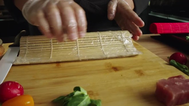 https://motionarray.imgix.net/preparing-sushi-roll-with-bamboo-mat-1824690-high_0002.jpg?w=660&q=60&fit=max&auto=format