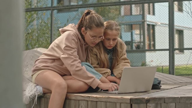 Preteen Girls Studying On Laptop At Playground - Stock Video | Motion Array