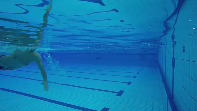 Male Swimmer Rotating In Water: Stock Video