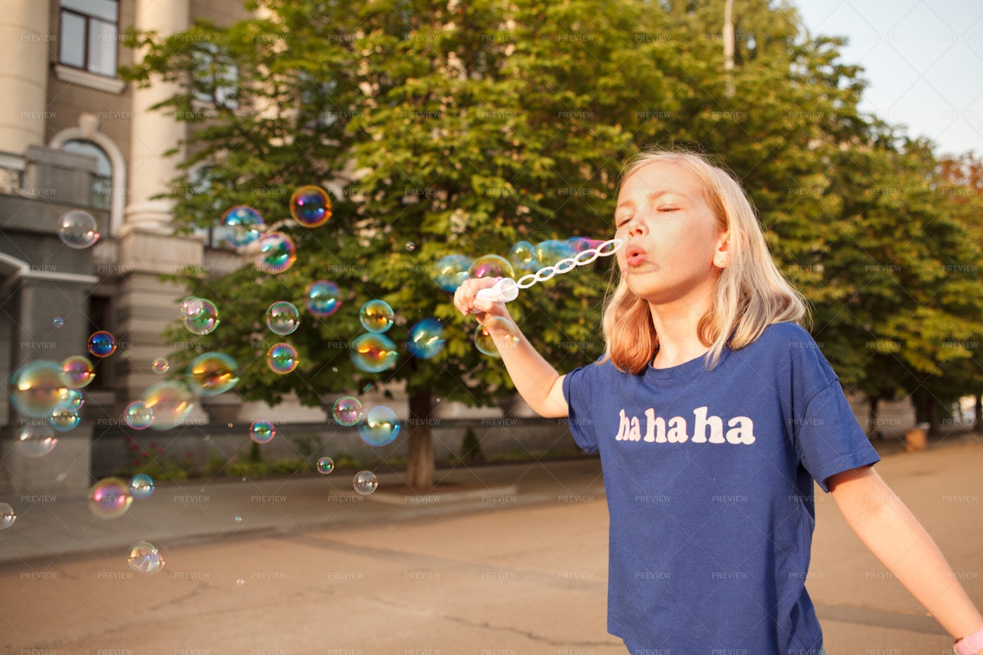 Young Girl Blowing Bubbles Outdoors: Stock Photos