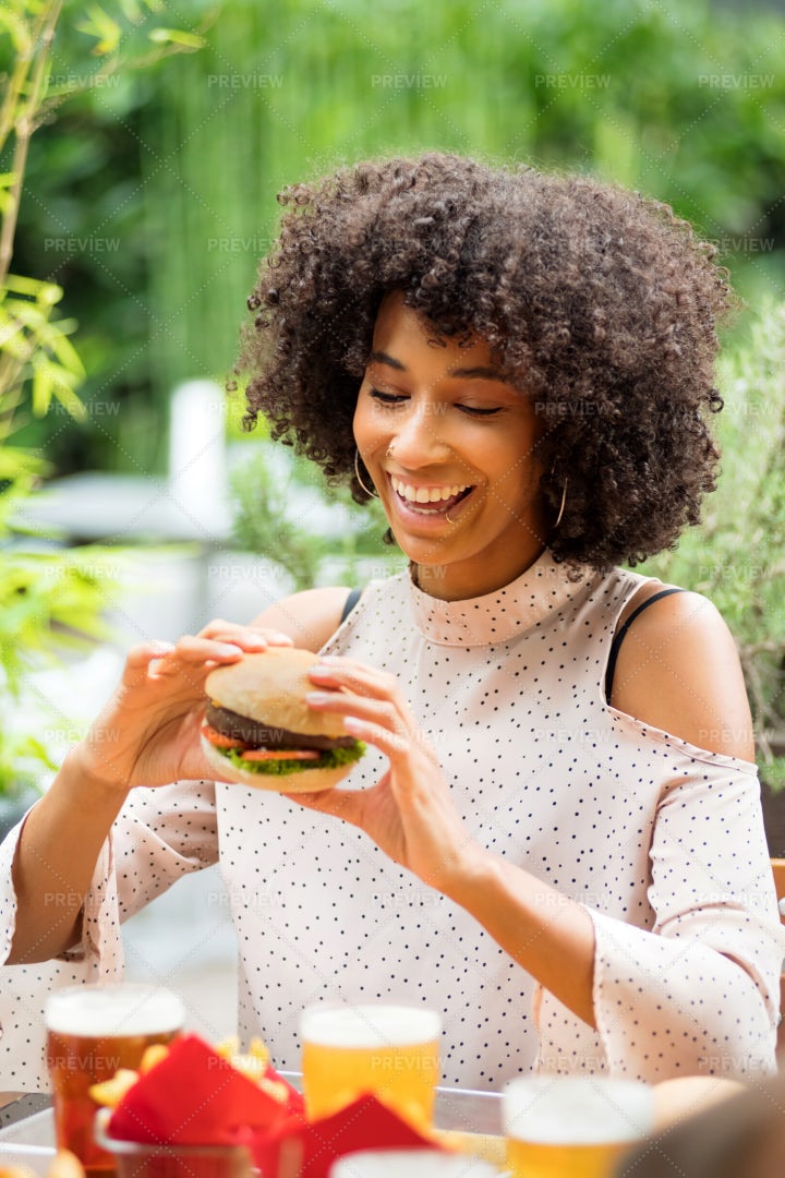 Woman Eating Hamburger: Stock Photos