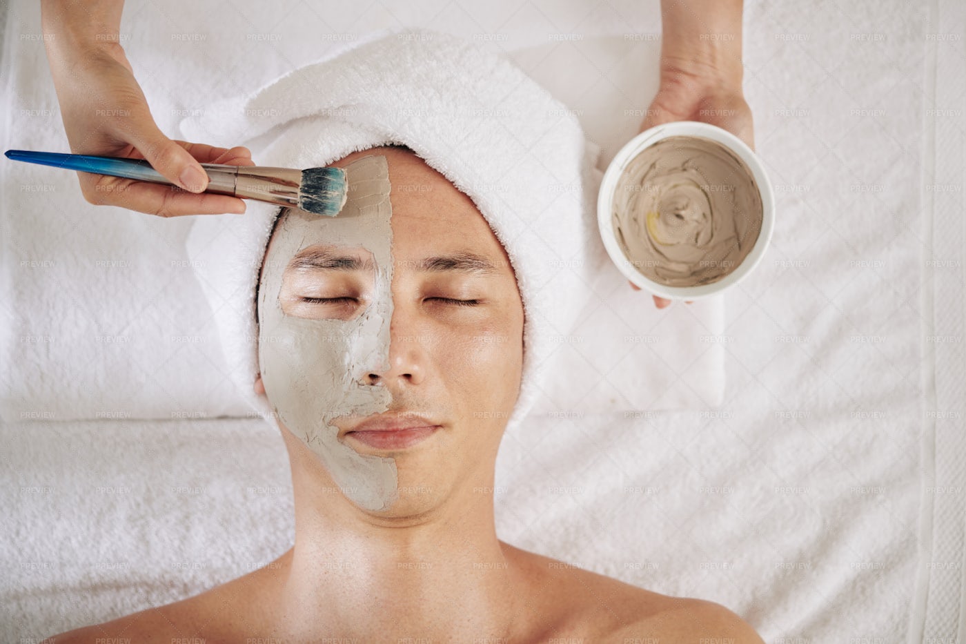 Cosmetologist Applying Charcoal Mask: Stock Photos