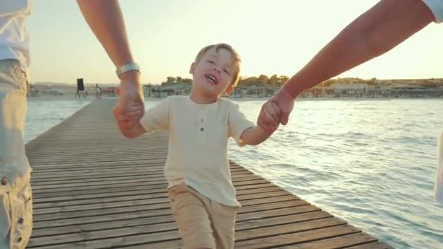 Happy Boy Walking With Grandparents: Stock Video