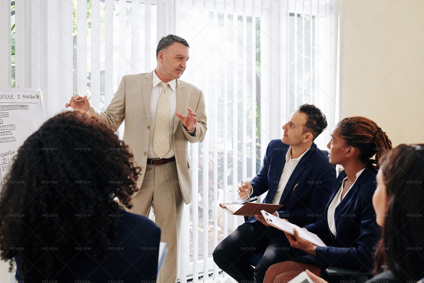 Entrerpreneur Talking To Colleagues: Stock Photos