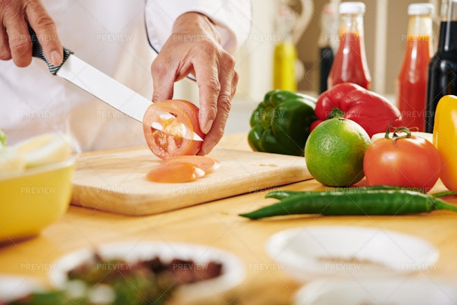 Chef is chopping vegetables Stock Photo by grafvision