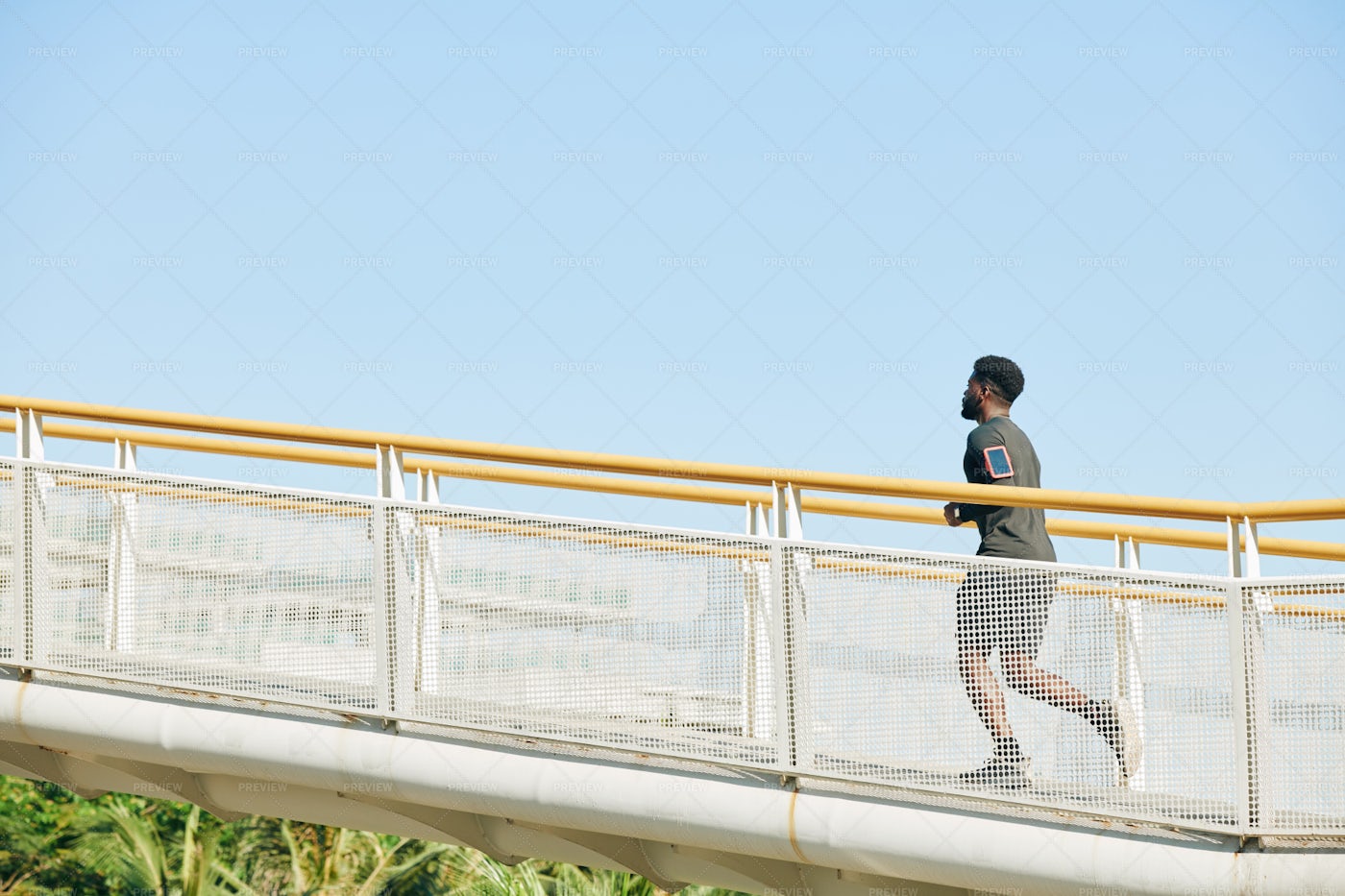 Man Running Along The Bridge: Stock Photos