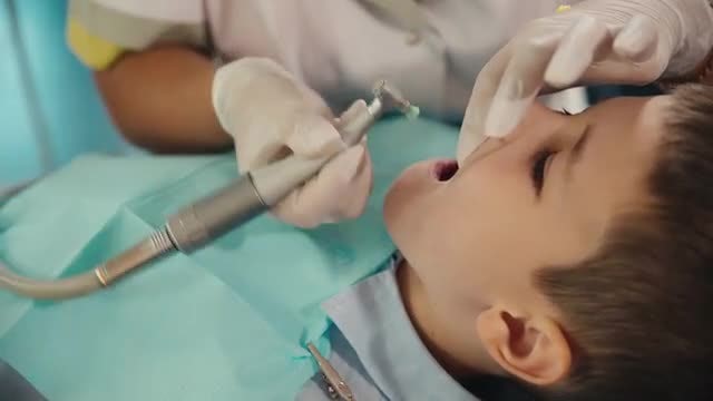 Dentist Treating A Boy: Stock Video