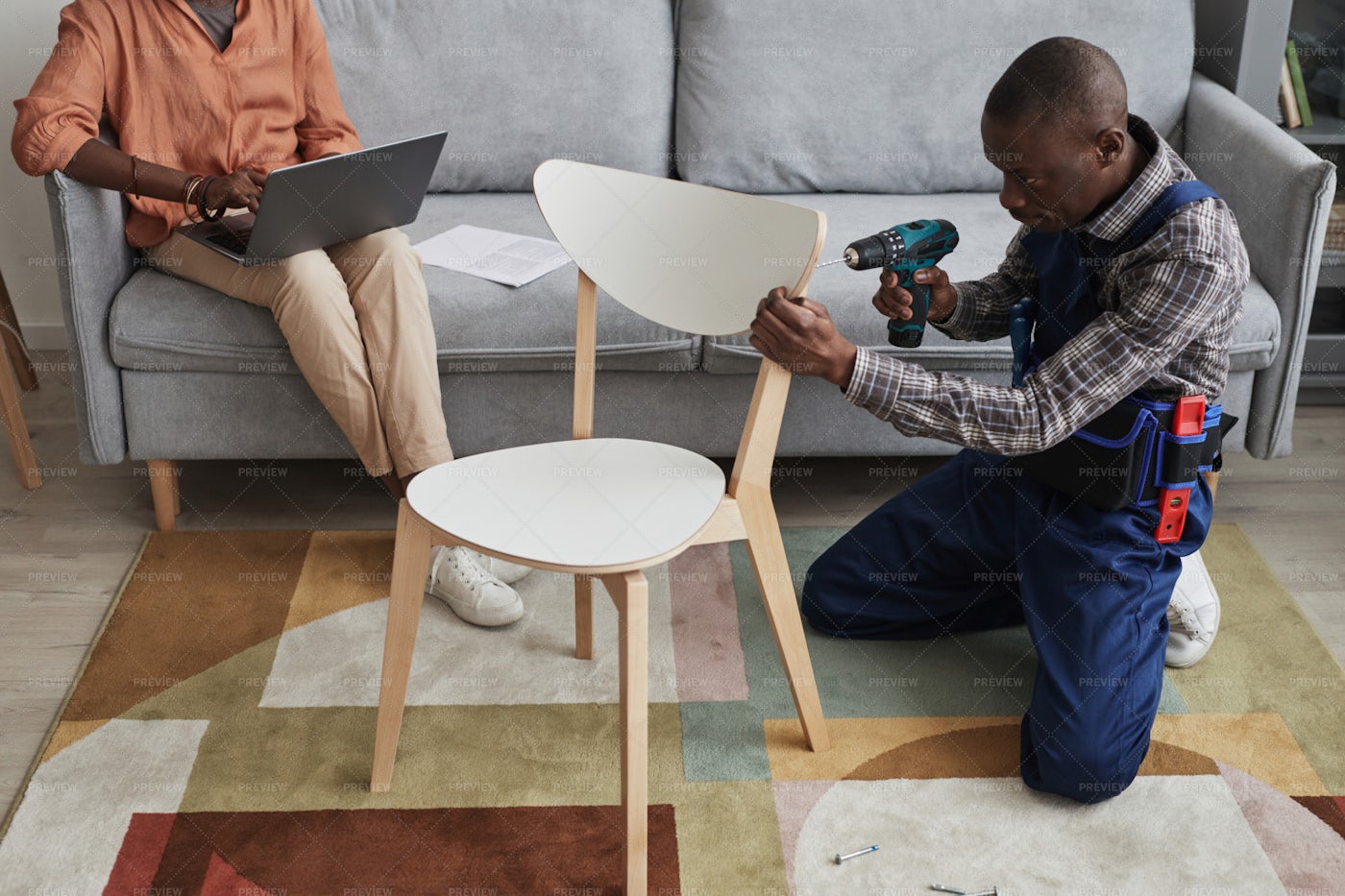 Handyman Assembling A Chair: Stock Photos