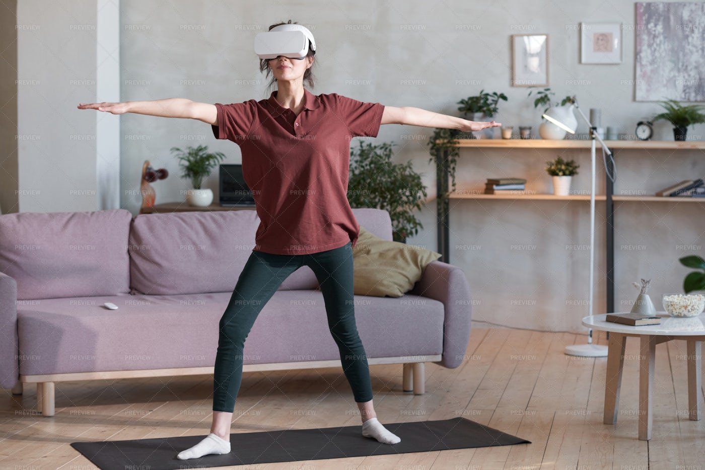 Woman Exercising In VR Headset: Stock Photos