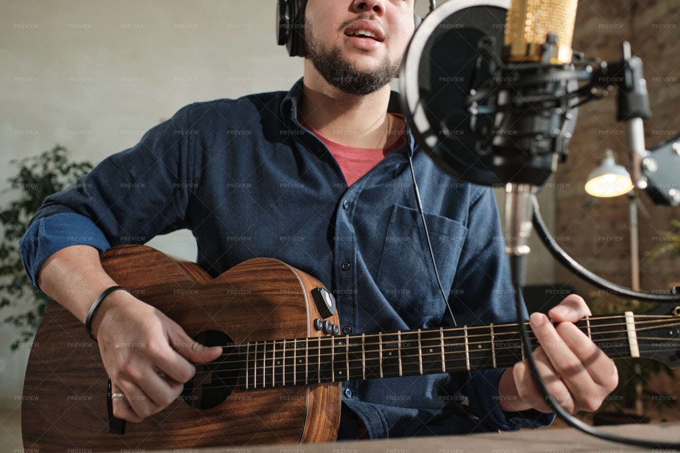 Man Playing Guitar In Studio: Stock Photos