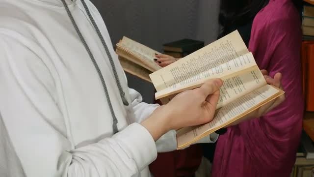 Two Students Reading Books In Library: Stock Video