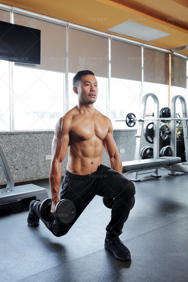 Man Concentrated On Doing Lunges: Stock Photos