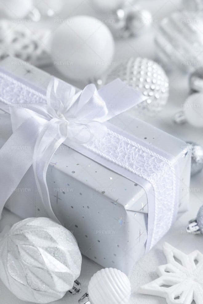 Christmas present with blue bow and silver decorations closeup Stock Photo  by katrinshine