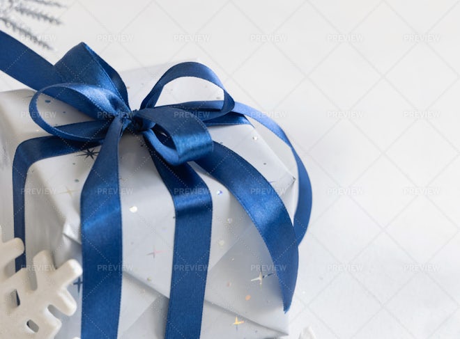 Four Presents Wrapped In White Gift Wrap With Blue Bows Stock Photo -  Download Image Now - iStock