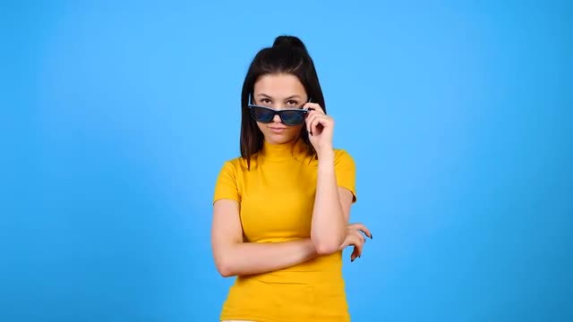 Young Woman Playing With Sunglasses: Stock Video